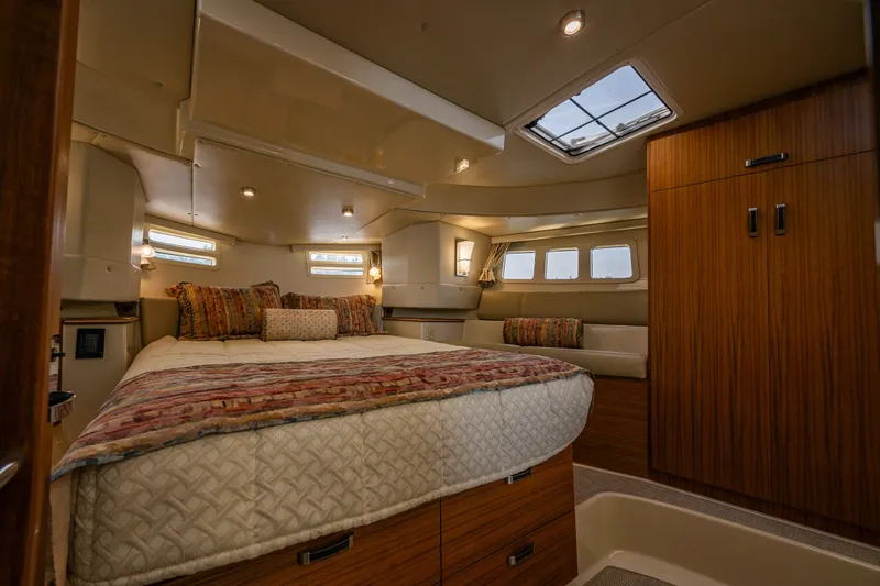 Slide: The Image of Luxurious 2020 Ranger Tugs R-41 CB cabin interior with cozy bed and elegant wood finishes. - 29