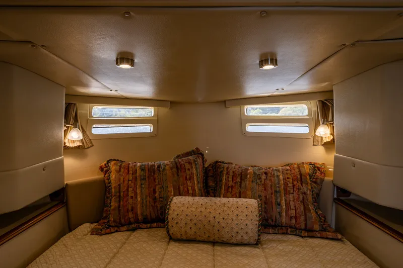 Slide: The Image of Cozy cabin interior of 2020 Ranger Tugs R-41 CB with plush bedding and ambient lighting. - 30