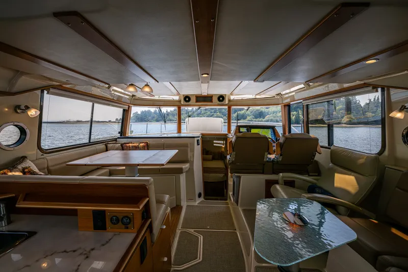 Slide: The Image of Interior of 2020 Ranger Tugs R-41 CB yacht with spacious seating and scenic windows. - 23
