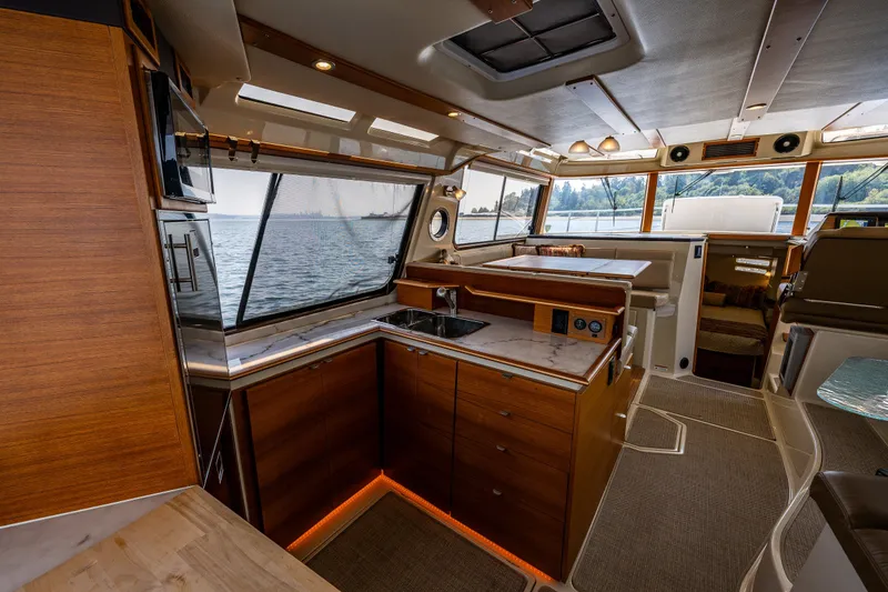 Slide: The Image of Luxurious interior of 2020 Ranger Tugs R-41 CB yacht with modern kitchen and scenic windows. - 21