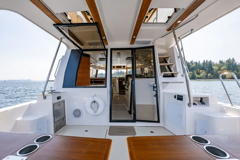 Slide: The Image of 2020 Ranger Tugs R-41 CB yacht interior with open deck and scenic water view. - 15