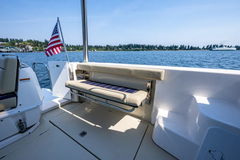Slide: The Image of 2020 Ranger Tugs R-41 CB boat deck with seating and American flag on a sunny day. - 13