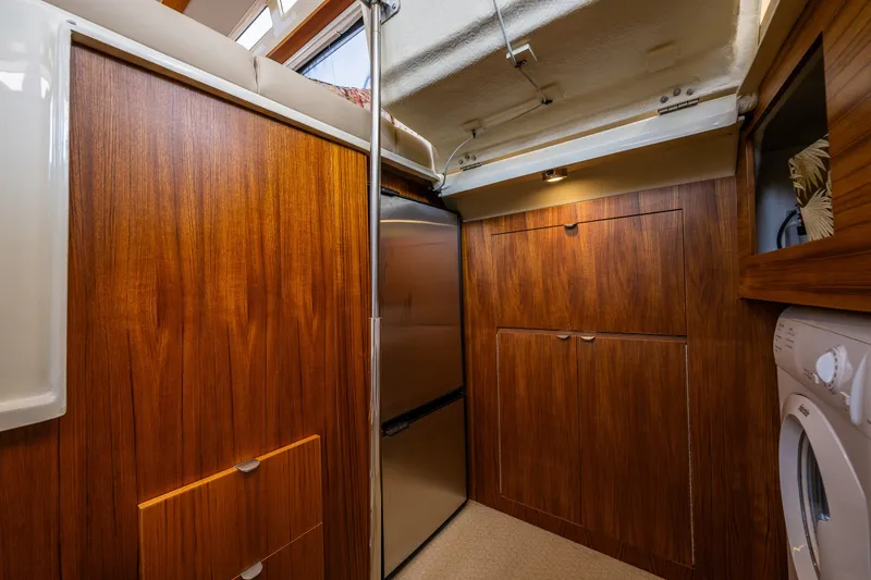 Slide: The Image of Interior of 2020 Ranger Tugs R-41 CB with wood cabinetry and modern appliances. - 37