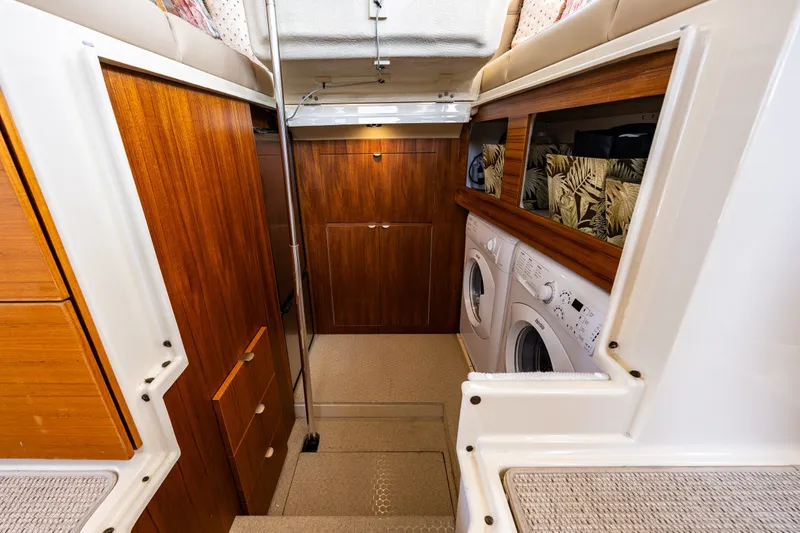 Slide: The Image of Interior of 2020 Ranger Tugs R-41 CB with wood cabinetry and laundry appliances. - 38