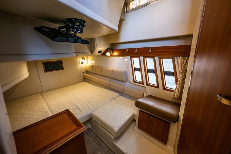 Slide: The Image of Luxurious interior cabin of 2020 Ranger Tugs R-41 CB with cozy bed and elegant wood finishes. - 41