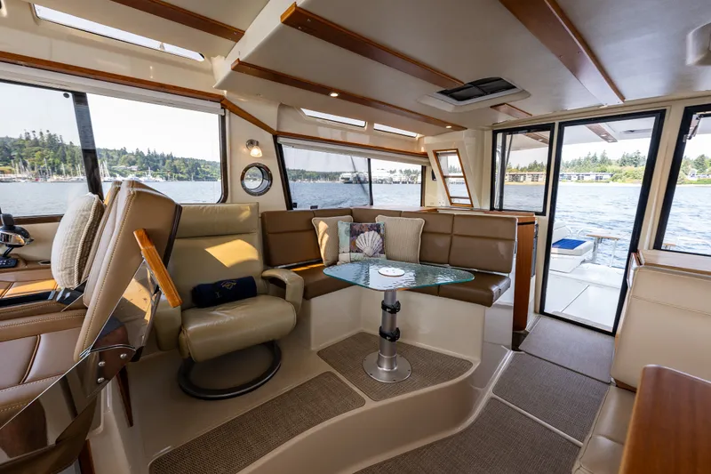 Slide: The Image of Interior of 2020 Ranger Tugs R-41 CB yacht with elegant seating and scenic water views. - 24