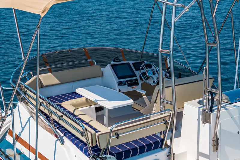 Slide: The Image of 2020 Ranger Tugs R-41 CB boat cockpit with seating and navigation controls on open water. - 8