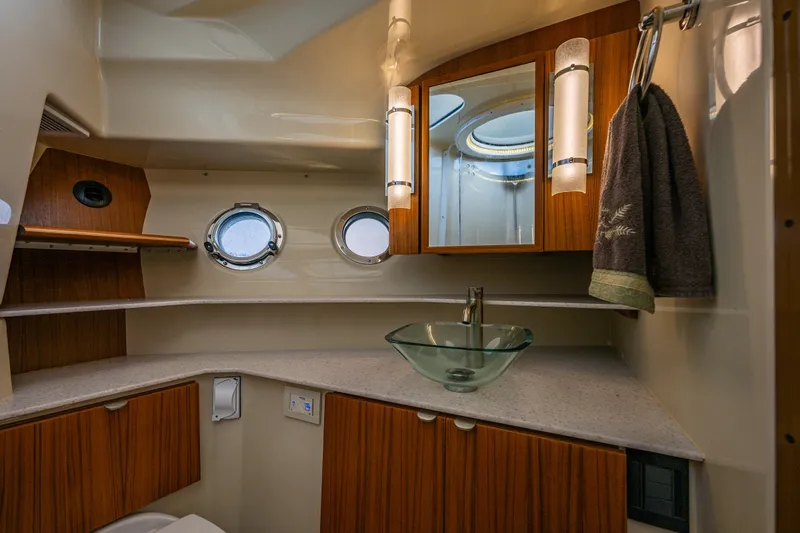 Slide: The Image of Luxurious 2020 Ranger Tugs R-41 CB bathroom with modern glass sink and wooden cabinetry. - 33