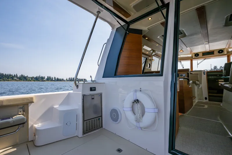 Slide: The Image of 2020 Ranger Tugs R-41 CB boat interior with open deck and scenic water view. - 16