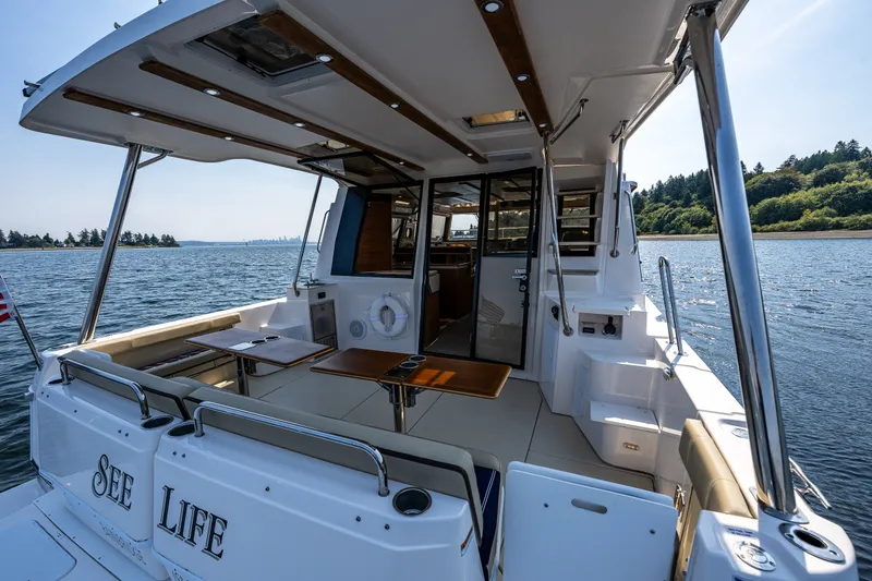 Slide: The Image of 2020 Ranger Tugs R-41 CB boat with spacious deck, cruising on a scenic waterway. - 9