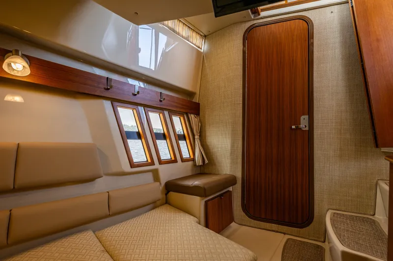 Slide: The Image of Interior of 2020 Ranger Tugs R-41 CB, featuring cozy seating and wooden door. - 42