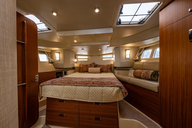 Slide: The Image of Luxurious 2020 Ranger Tugs R-41 CB cabin interior with cozy bed and elegant wood finishes. - 28