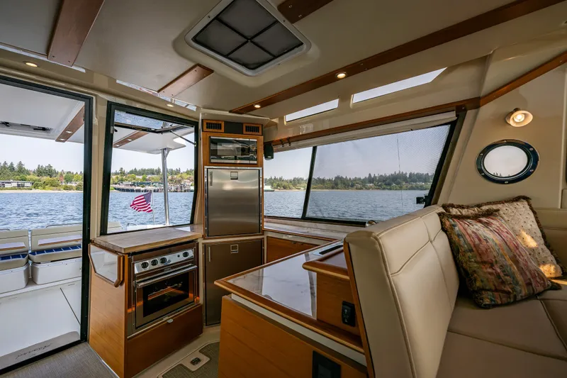 Slide: The Image of Interior of 2020 Ranger Tugs R-41 CB yacht with kitchen and scenic water view. - 22