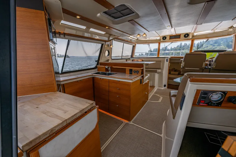 Slide: The Image of Interior of 2020 Ranger Tugs R-41 CB yacht with modern kitchen and scenic windows. - 40