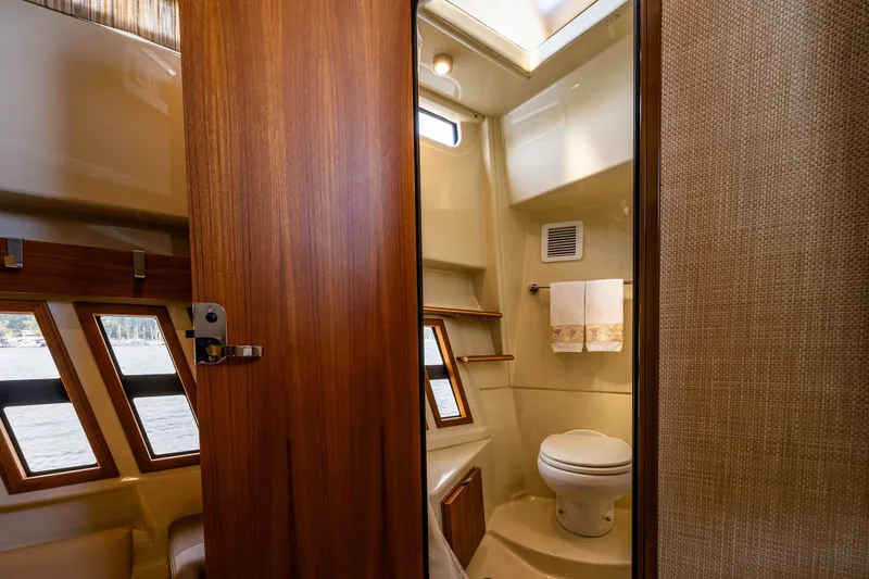 Slide: The Image of 2020 Ranger Tugs R-41 CB yacht bathroom with wood accents and natural light. - 43