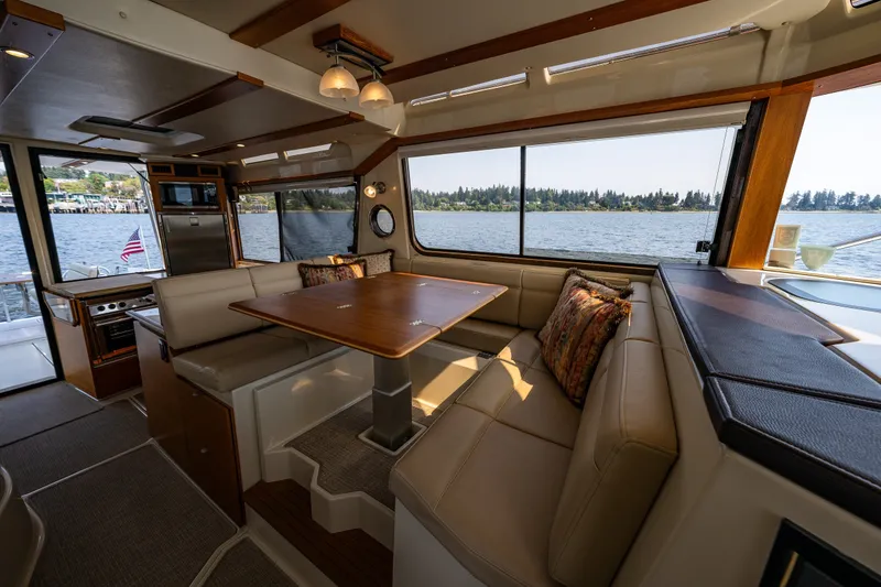 Slide: The Image of Interior of 2020 Ranger Tugs R-41 CB yacht with elegant dining area and scenic water view. - 36