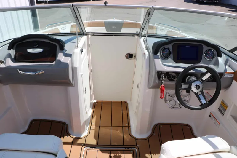 Slide: The Image of The image shows the cockpit of a 2023 Chaparral 23 SSi boat with modern instruments. - 30
