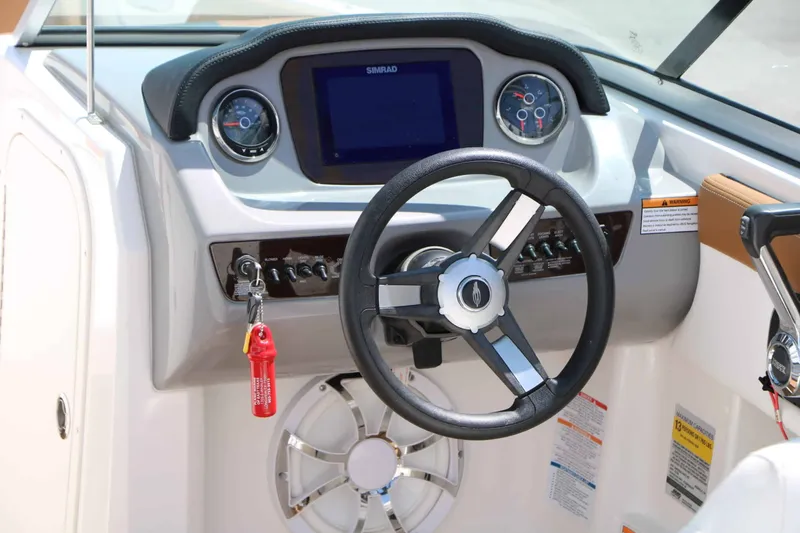 Slide: The Image of The image shows the helm of a Chaparral 23 SSi with modern instruments and a display screen. - 22