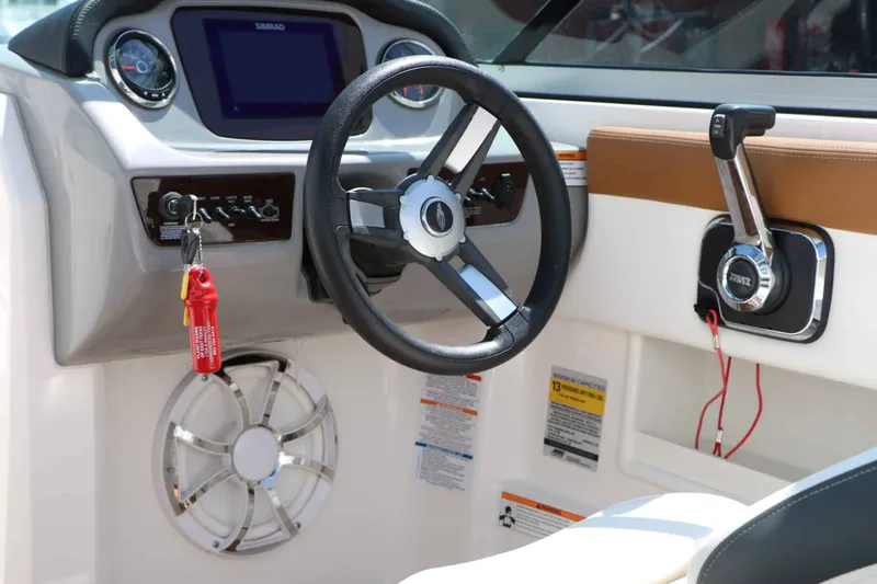 Slide: The Image of The image shows the cockpit of a Chaparral 23 SSi with steering wheel and control console. - 29