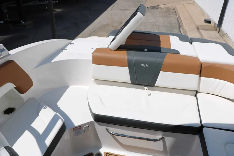 Slide: The Image of The image shows the cockpit of a 2023 Chaparral 23 SSi boat with cushioned seating. - 43
