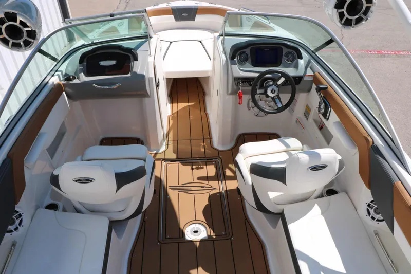 Slide: The Image of The image shows the cockpit of a 2023 Chaparral 23 SSi boat with modern seating and controls. - 26