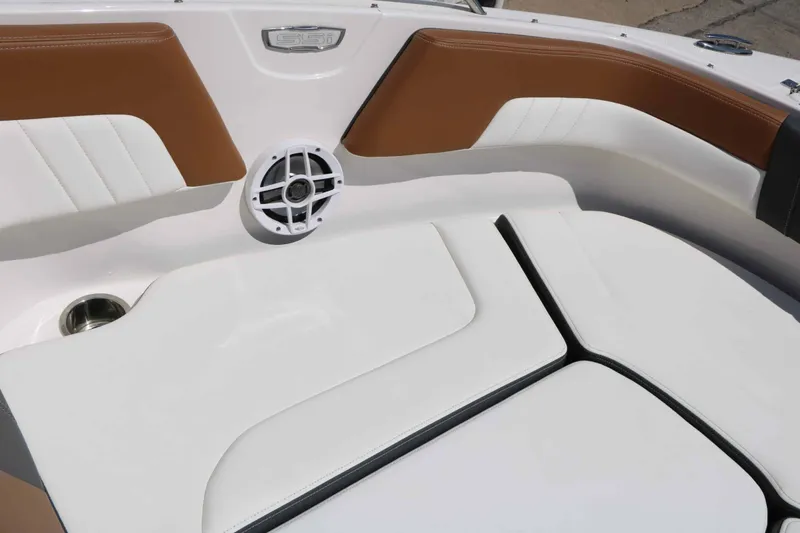 Slide: The Image of The image shows the bow area of a Chaparral 23 SSi boat with white and brown upholstery. - 32