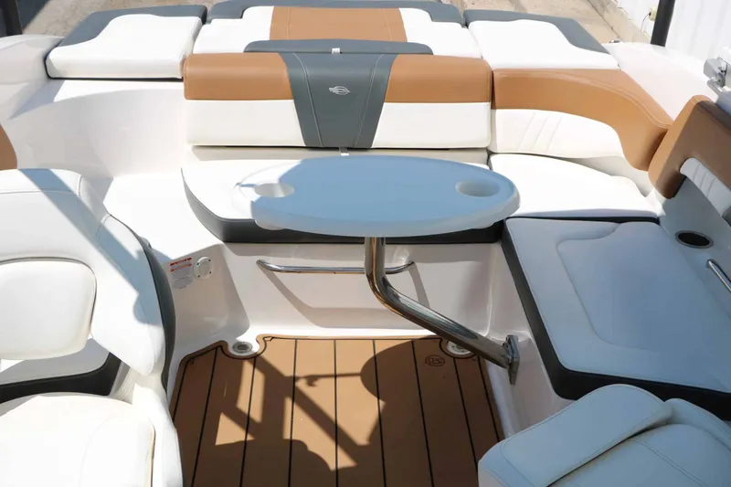 Slide: The Image of The image shows the interior of a Chaparral 23 SSi boat with sleek seating and a table. - 50