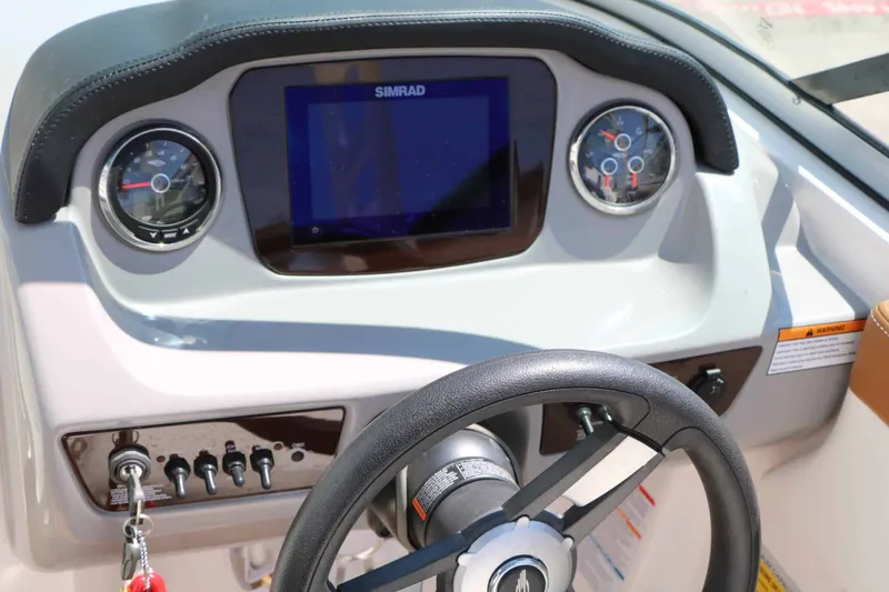 Slide: The Image of The image shows the dashboard of a Chaparral 23 SSi boat with a Simrad display. - 31
