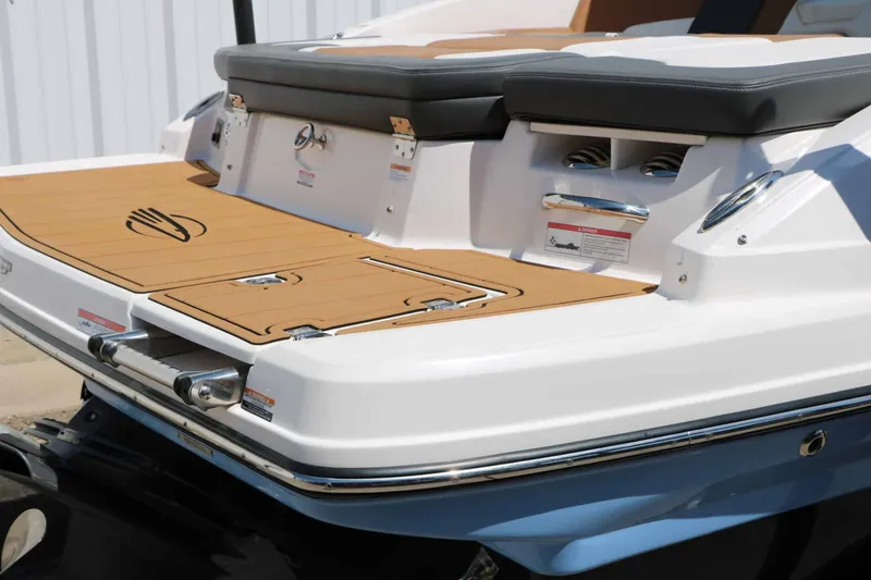 Slide: The Image of The image shows the stern of a 2023 Chaparral 23 SSi boat with cushioned seats. - 14