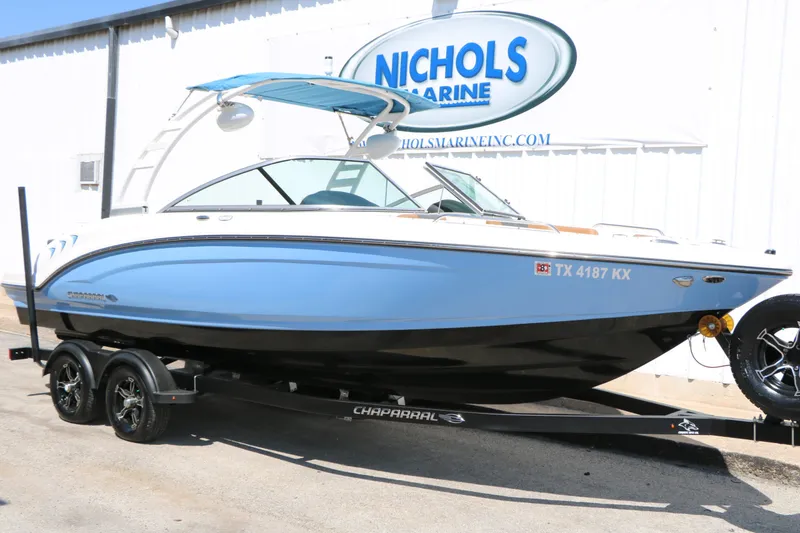The Image of A 2023 Chaparral 23 SSi boat on a trailer in front of a building. - 1