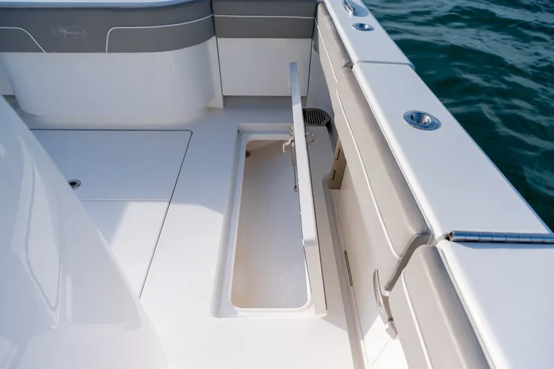 Slide: The Image of 2021 Valhalla V-33 boat interior with open storage compartment, near water. - 36