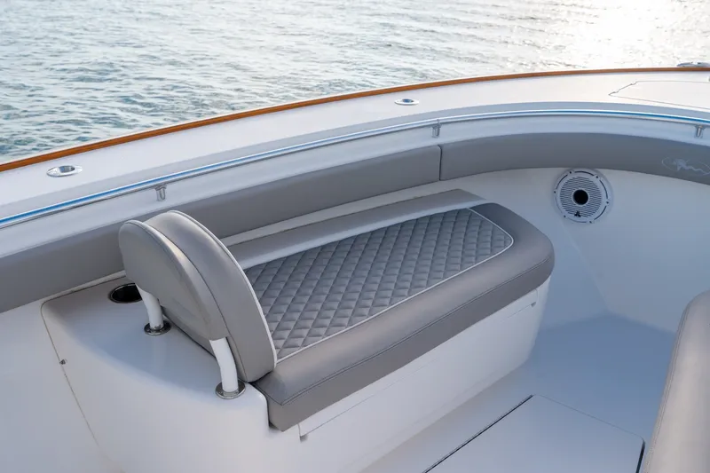 Slide: The Image of Valhalla V-33 2021 boat interior with gray cushioned seating and ocean view. - 24