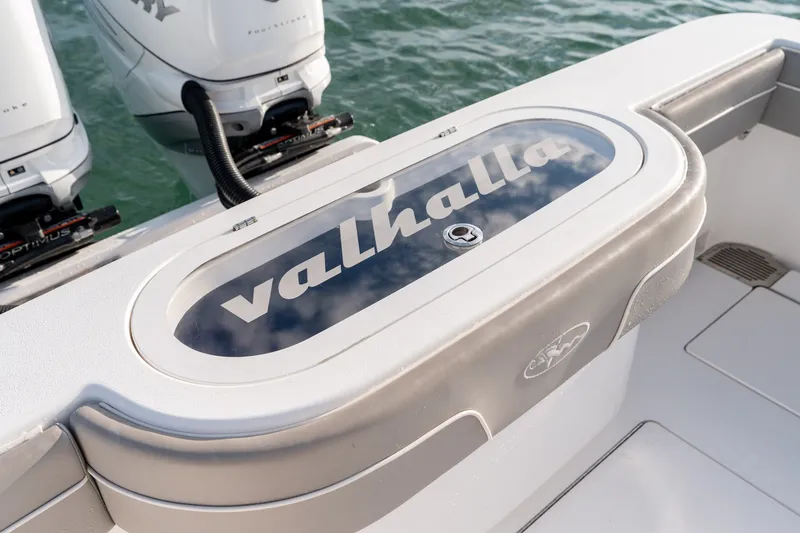 Slide: The Image of Valhalla V-33 boat deck with logo, 2021 model, featuring twin outboard engines. - 14