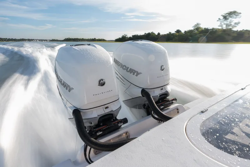 Slide: The Image of Twin Mercury outboard engines powering a 2021 Valhalla V-33 boat at high speed. - 9