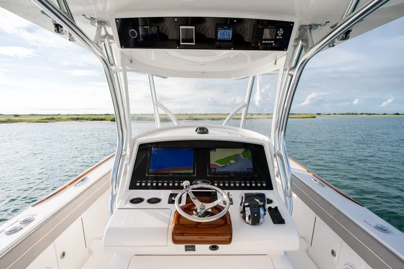 Slide: The Image of Valhalla V-33 2021 boat helm with navigation screens on open water. - 19