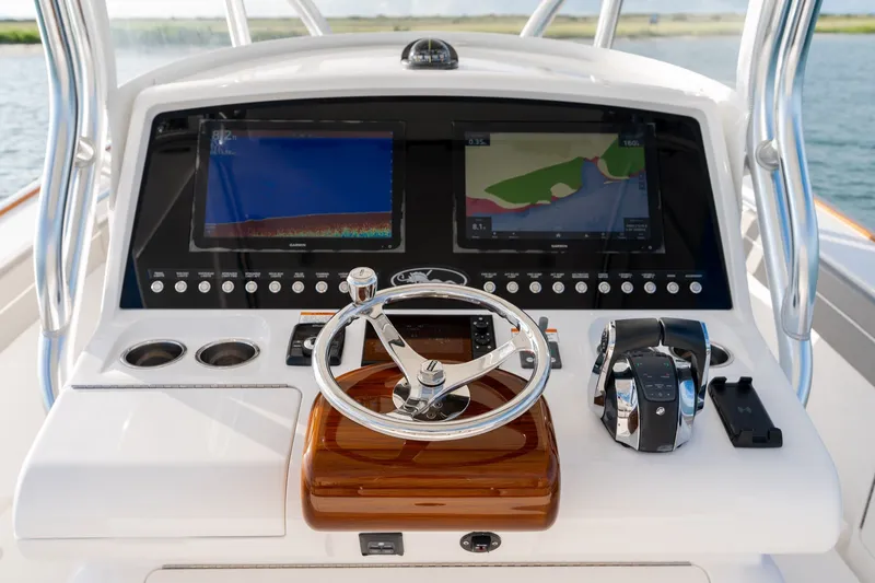Slide: The Image of Valhalla V-33 2021 boat dashboard with dual screens and steering wheel. - 20