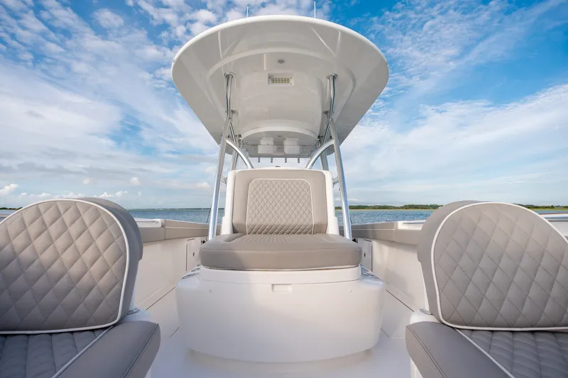 Slide: The Image of Valhalla V-33 boat interior with cushioned seating, 2021 model, under a clear blue sky. - 30