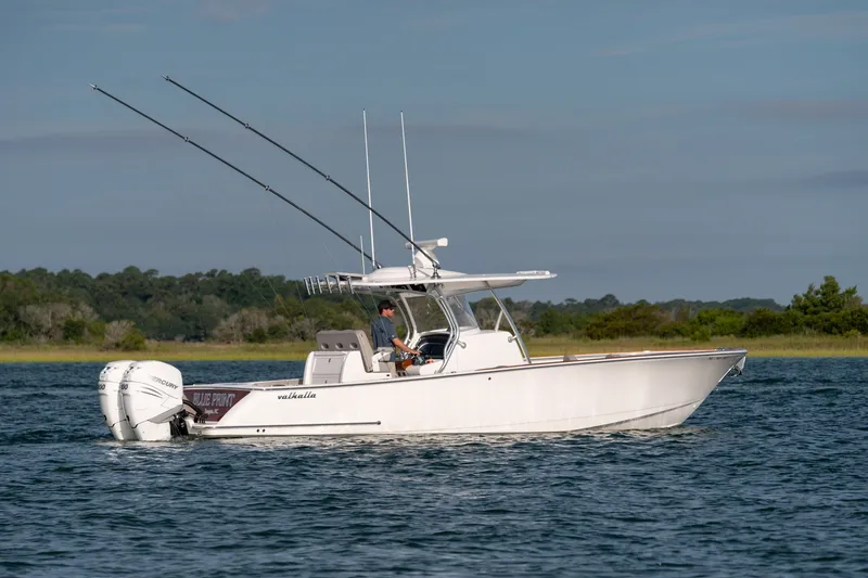 Slide: The Image of Valhalla V-33 boat cruising on water, 2021 model, with dual outboard engines. - 4