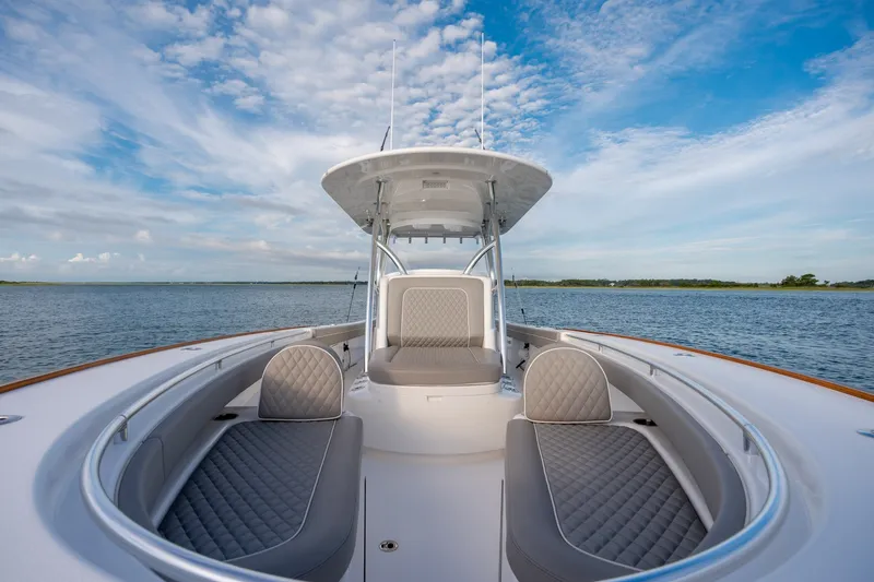 Slide: The Image of Valhalla V-33 2021 boat interior with luxurious seating on a serene water backdrop. - 29