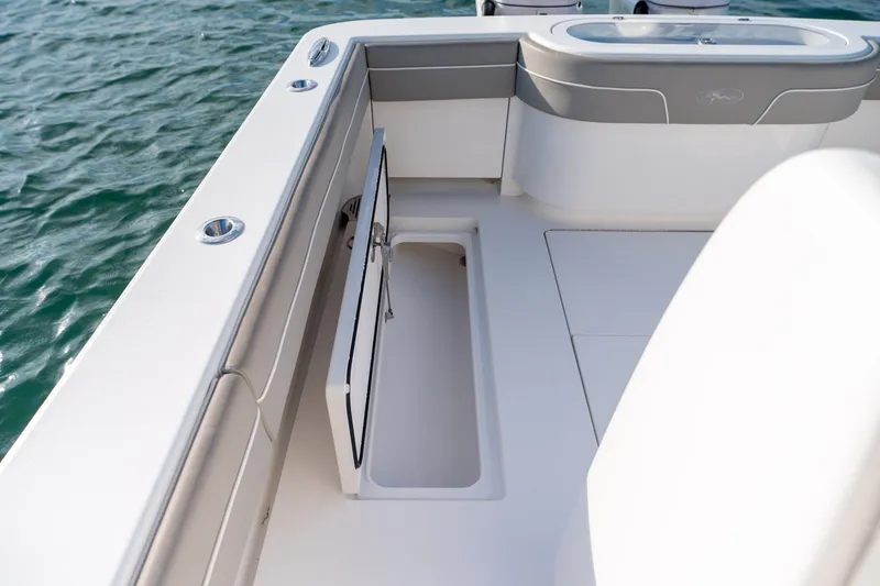 Slide: The Image of Valhalla V-33 boat interior, 2021 model, featuring sleek seating and storage on calm water. - 37