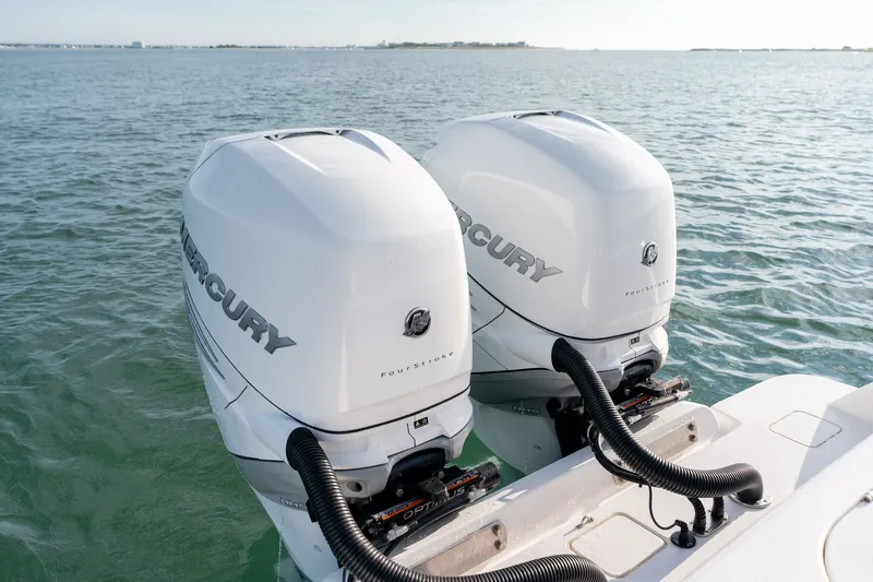 Slide: The Image of Twin Mercury outboard engines on a 2021 Valhalla V-33 boat in open water. - 13