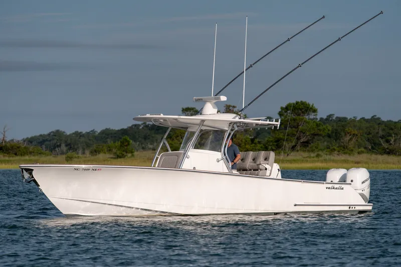 The Image of 2021 Valhalla V-33 boat cruising on a calm lake with fishing rods. - 0