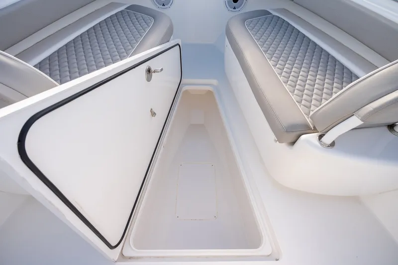 Slide: The Image of Open storage compartment on 2021 Valhalla V-33 boat with cushioned seating. - 31