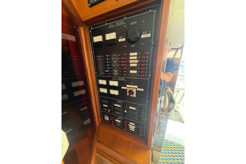 Slide: The Image of Electrical control panel on a 2002 Seahorse 45 MY boat, featuring DC and AC switches. - 27
