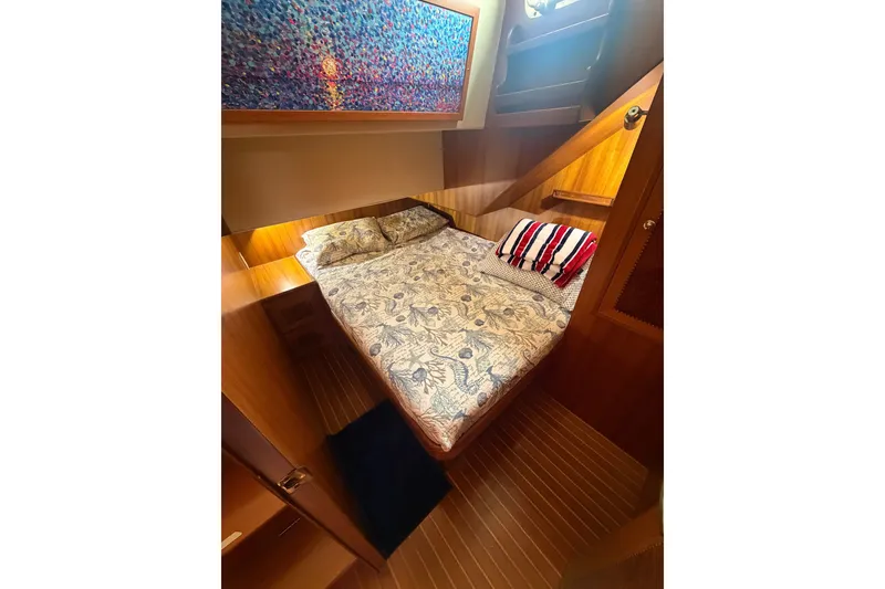 Slide: The Image of Cozy cabin interior of 2002 Seahorse 45 MY yacht with patterned bedding and vibrant artwork. - 29