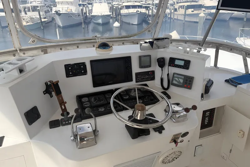 Slide: The Image of Helm of 2002 Seahorse 45 MY yacht with navigation equipment and marina view. - 14
