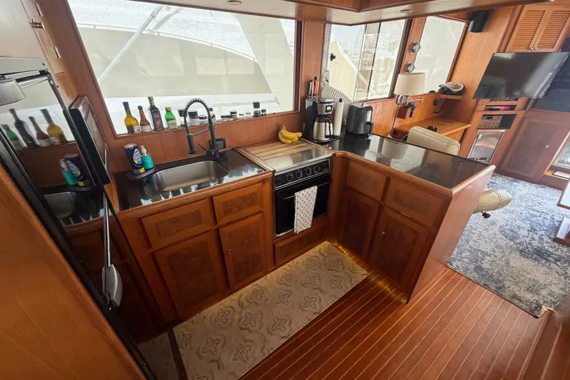 Slide: The Image of Luxurious 2002 Seahorse 45 MY yacht interior with modern kitchen and elegant wood finishes. - 23