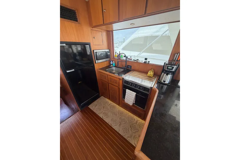 Slide: The Image of Compact kitchen in 2002 Seahorse 45 MY yacht with stove, sink, and refrigerator. - 22