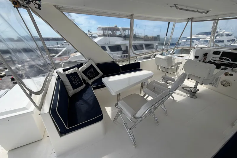 Slide: The Image of Luxurious 2002 Seahorse 45 MY yacht interior with seating and helm, docked at marina. - 15