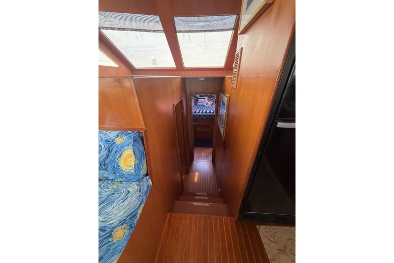 Slide: The Image of Interior of 2002 Seahorse 45 MY yacht with wooden stairs and vibrant upholstery. - 20